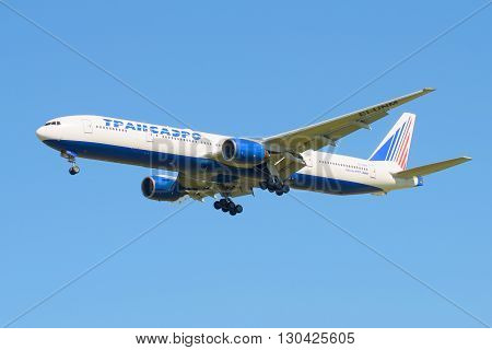 SAINT PETERSBURG, RUSSIA - AUGUST 21, 2015: The Boeing 777-312 (EI-UNM) of the company Transaero before landing in Pulkovo airport