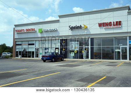 JOLIET, ILLINOIS / UNITED STATES - AUGUST 16, 2015: One may eat Chinese food at Weng Lee Chinese Kitchen, sign up for Sprint cellular telephone service, have one's taxes prepared at H&R Block, and have one's teeth cleaned at Today's Dental.