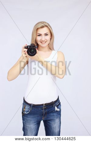 Happy smiling woman holding dslr camera on isolated background