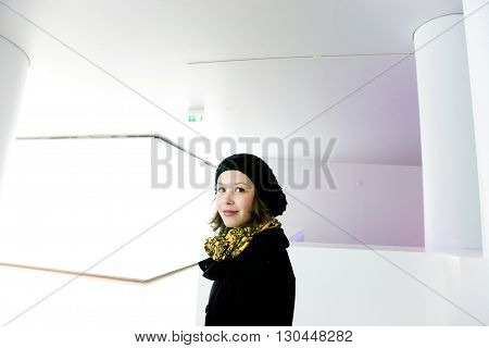 Portrait Of A Smiling Young Girl In A White Room