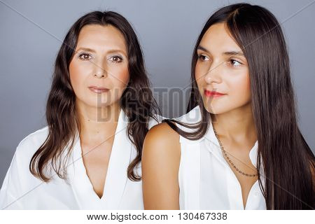 cute pretty teen daughter with mature mothr hugging, fashion style brunette 