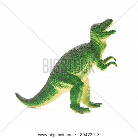 side view green plastic dinosaur toy on a white background