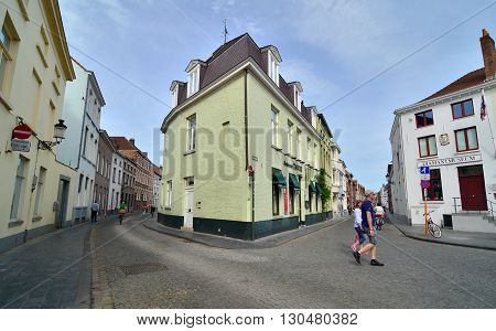 Bruges Belgium - May 11 2015: Tourists walking on street in the center of Bruges city Belgium. Bruges is the capital and largest city of the province of West Flanders in the Flemish Region of Belgium.