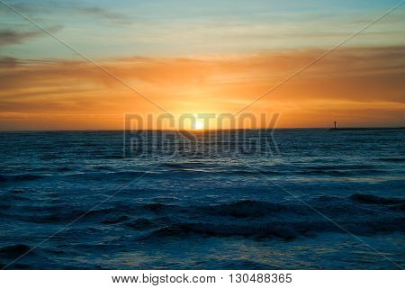 Sunset in Half Moon Bay California creating beautiful colors over ocean.