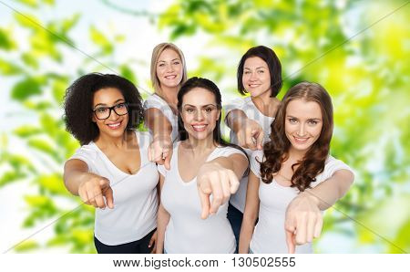 choice, friendship, body positive, gesture and people concept - group of happy different size women in white t-shirts pointing finger on you over green natural summer background