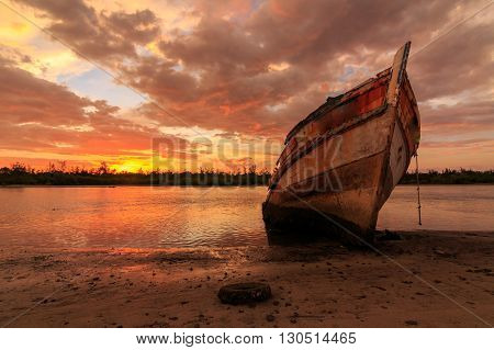 Abandoned Ship during sunset moment at Sabah Borneo Malaysia Image has grain or blurry or noise and soft focus when view at full resolution. (Shallow DOF, slight motion blur)