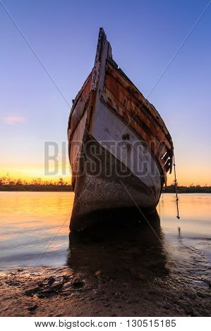 Abandoned Ship during sunset moment at Sabah Borneo Malaysia Image has grain or blurry or noise and soft focus when view at full resolution. (Shallow DOF, slight motion blur)