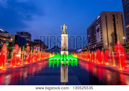 SEOUL SOUTH KOREA - APRIL 30 2016:Beautifully color water fountain at Gwanghwamun Plaza with the statue of the Admiral Yi Sun-sin in downtown.Photo taken on April 302016 in seoulSouth Korea.