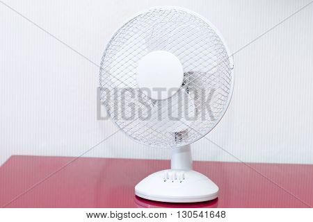 White table ventilator with spinning blades closeup
