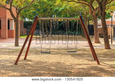 Two seats swings at children' playground in park
