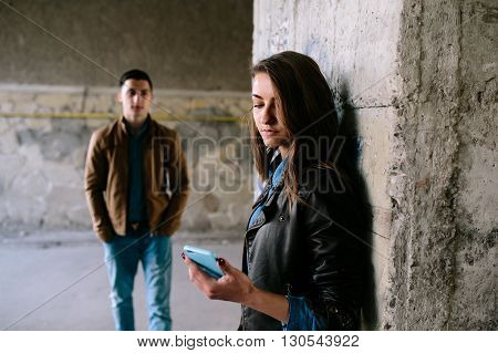 handsome guy and beautiful girl posing in a bystreet