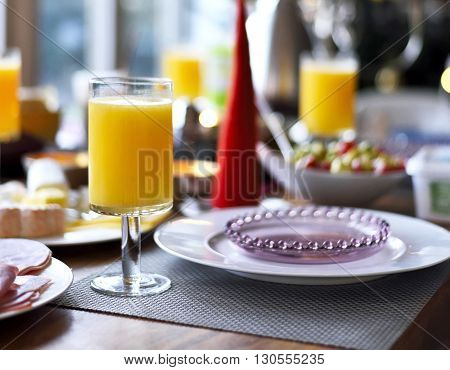 Breakfast with fresh orange juice. Breakfast table setting.