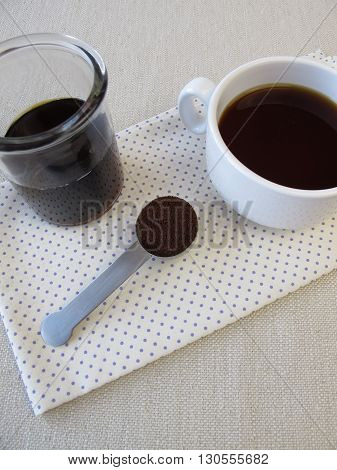 Cup of cold brewed coffee and coffee concentrate
