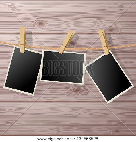 Photo Frame Fixed Hanging with Clothespins on Wooden Background