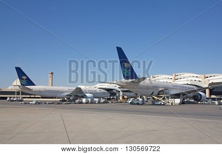 Riyadh - March 01:  Planes preparing for take off at Riyadh King Khalid Airport on March 01, 2016 in Riyadh, Saudi Arabia. Riyadh airport is home port for Saudi Arabian Airlines.