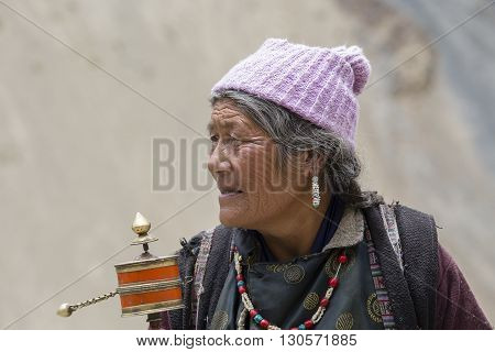 LAMAYURU INDIA - JUNE 13 2015: Unidentified buddhist old women during mystical mask dancing Tsam mystery dance in time of Yuru Kabgyat Buddhist festival at Lamayuru Gompa Ladakh North India