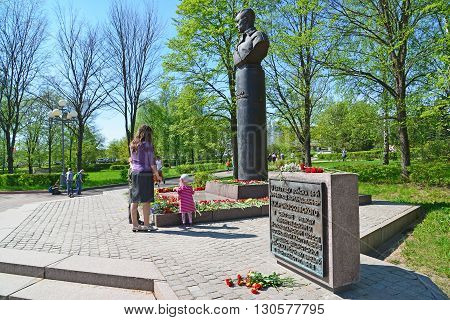 Zelenograd, Russia - May 09 .2016: Mom and daughter laying flowers at the monument to Marshal Rokossovsky in Victory Park