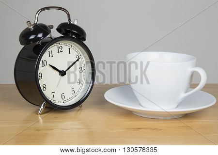 Bell alarm clock and cup of tea