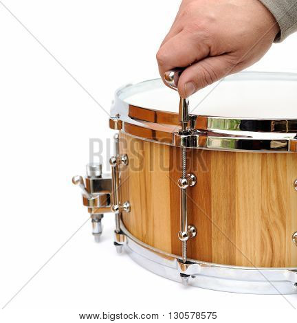 Master tuning new wooden snare drum isolated closeup