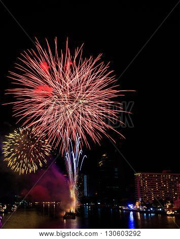 Fireworks over Chaopraya river near hotel in Bangkok Thailand