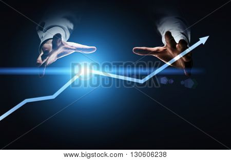 Financial growth concept with businessman hands willing to grab illuminated arrow pointed upwards