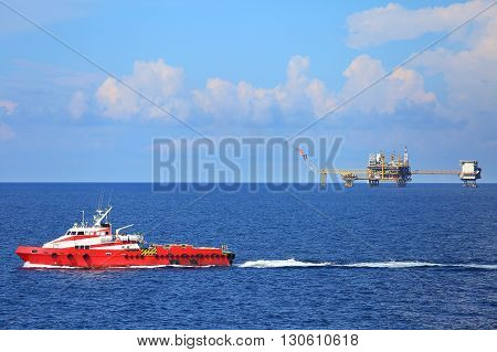 Supply boat transfer cargo to oil and gas industry and moving cargo from the boat to the platform, boat waiting transfer cargo and crews between oil and gas platform with the boat.