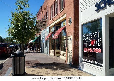 PLAINFIELD, ILLINOIS / UNITED STATES - SEPTEMBER 20, 2015: One may purchase works of art in the Lockport Street Gallery, and study music at the School of Rock, in downtown Plainfield.