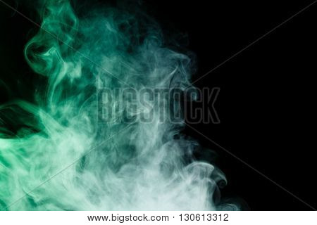 Abstract art. Virid smoke hookah on a black background. Inhalation. The steam generator. The concept of poison gas. Gas.