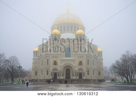 KRONSTADT, RUSSIA - MARCH 08, 2016: The Cathedral of St. Nicholas in the fog on a march day. View from Anchor square. Religious landmark of the city Kronstadt