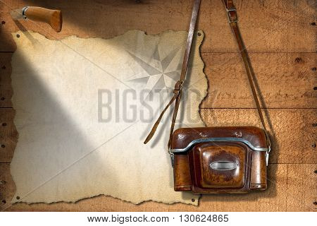 Old and vintage camera with leather case empty parchment with compass rose and a pen knife. Template for adventurous travels