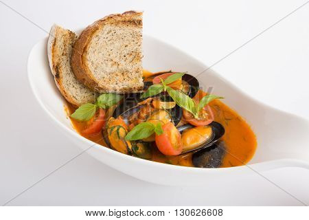 Fresh yellow italian mussels soup with croutons