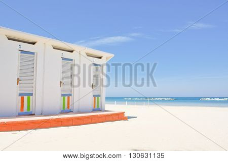 Cabins on the Adriatic beach and sea in the background