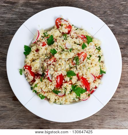 Homemade Fresh Couscous salad with vegetables, in white plate