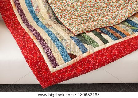Patchwork quilt. Part of patchwork quilt as background. A blanket in style patchwork. Color blanket. Handmade.