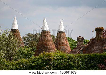 Kentish oast house roofs with white tops
