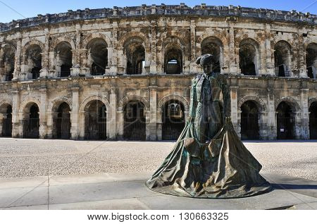 NIMES, FRANCE - MAY 12: Statue of bullfighter Christian Montcouquiol, Nimeno II, in front of the Arena of Nimes on May 12, 2015 in Nimes, France. This Roman amphitheater serves as bullring since 1863