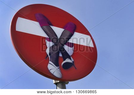 red stopsign in blue sky with a woman on it