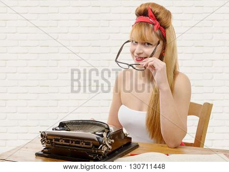 sexy young pinup girl with old typewriter