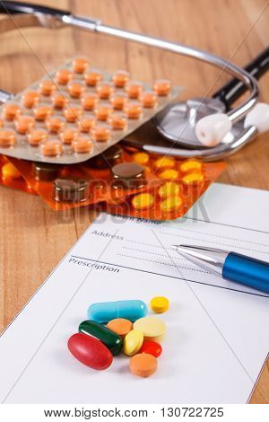 Medical pills tablets or supplements for therapy prescription and stethoscope on desk in doctor office concept of treatment and health care