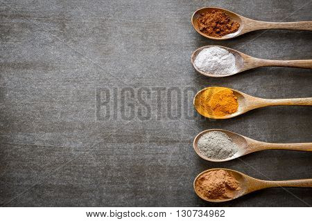 Various spices on wooden spoons. Food ingradients.