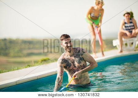Hipster tattooed guy have fun in open pool at summer