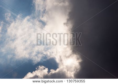 Dark storm clouds moving in from the right on the sun and a dark blue sky
