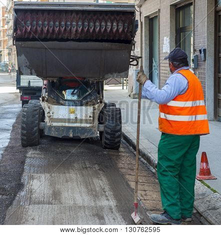 Sweeper attachments mini excavator. The sweeper sweeps collects and dumps dirt and debris.