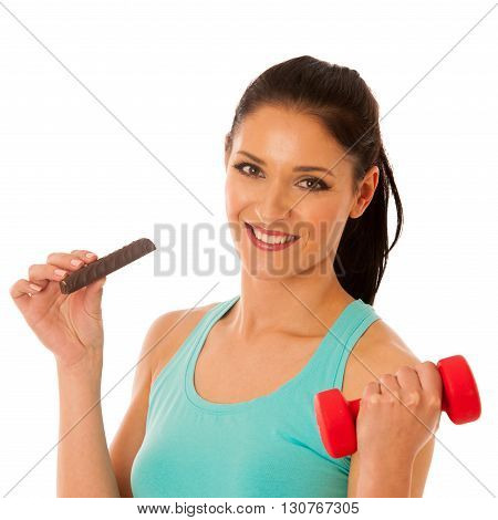 Woman Holding Red Dumbbell After Workout In Fitness Gym Eating Protein Bar Isolated Over White Backg