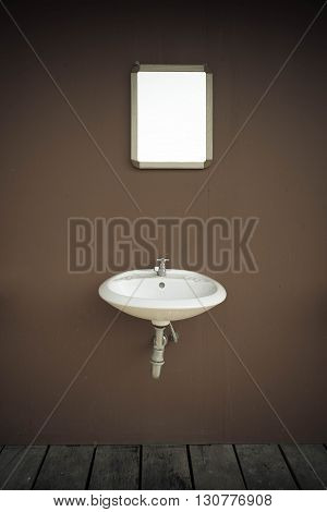 blank mirror and basin and wooden flloor in vintage style