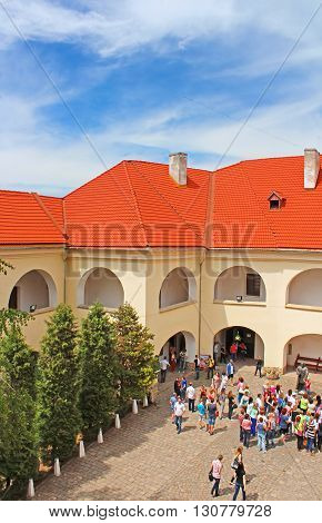 MUKACHEVE, UKRAINE - MAY 10, 2013: Unidentified people in Palanok Castle or Mukachevo Castle, Zakarpattya, Ukraine, built in 14th century. The Palanok Castle is delicately preserved and is located on a former 68 metre high volcanic hill