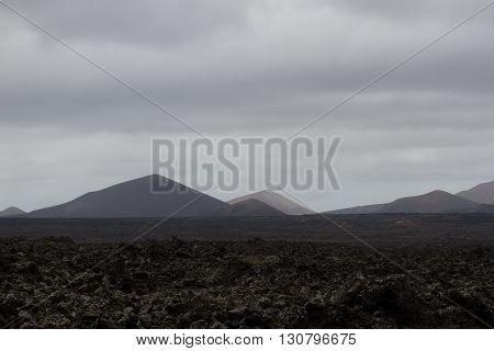 Desert arid stone volcanic landscape in Lanzarote, Canary Islands