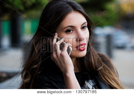 Beautiful businesswoman make call by mobile cell phone. Outdoor, over city