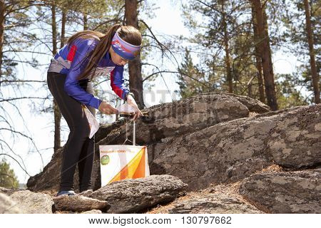 RUSSIA, ULAN-UDE - MAY 22, 2016: Russian Azimut - 2016. Orienteering competition is held annually in the Buryatia region. People at at control point at orienteering course.