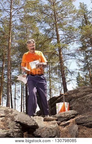 RUSSIA, ULAN-UDE - MAY 22, 2016: Russian Azimut - 2016. Orienteering competition is held annually in the Buryatia region. People at at control point at orienteering course.